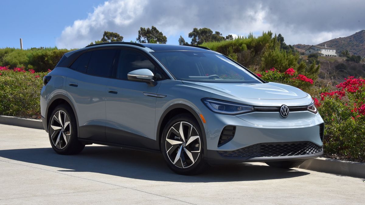2025 Volkswagen ID.4 parked on a street near green plants.