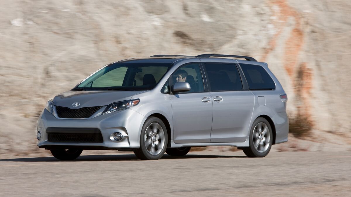 2012 Toyota Sienna driving past mountains.
