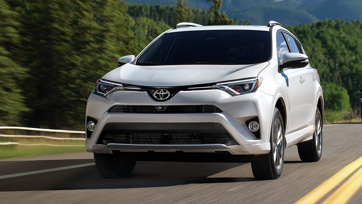 2018 Toyota RAV4 hybrid in white on the road.
