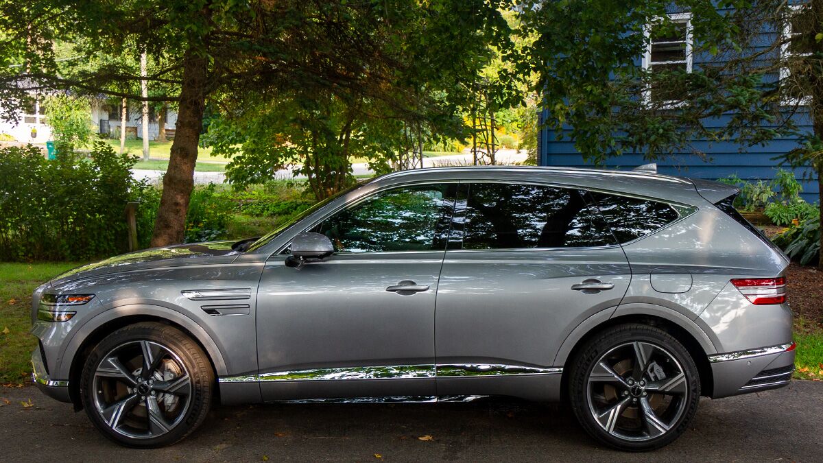 2024 Genesis GV80 parked in front of a driveway.