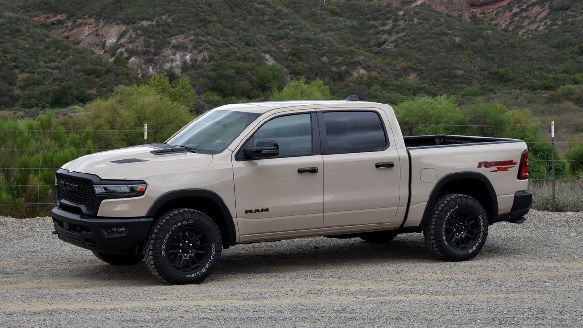 2025 Ram 1500 parked outside by greenery.