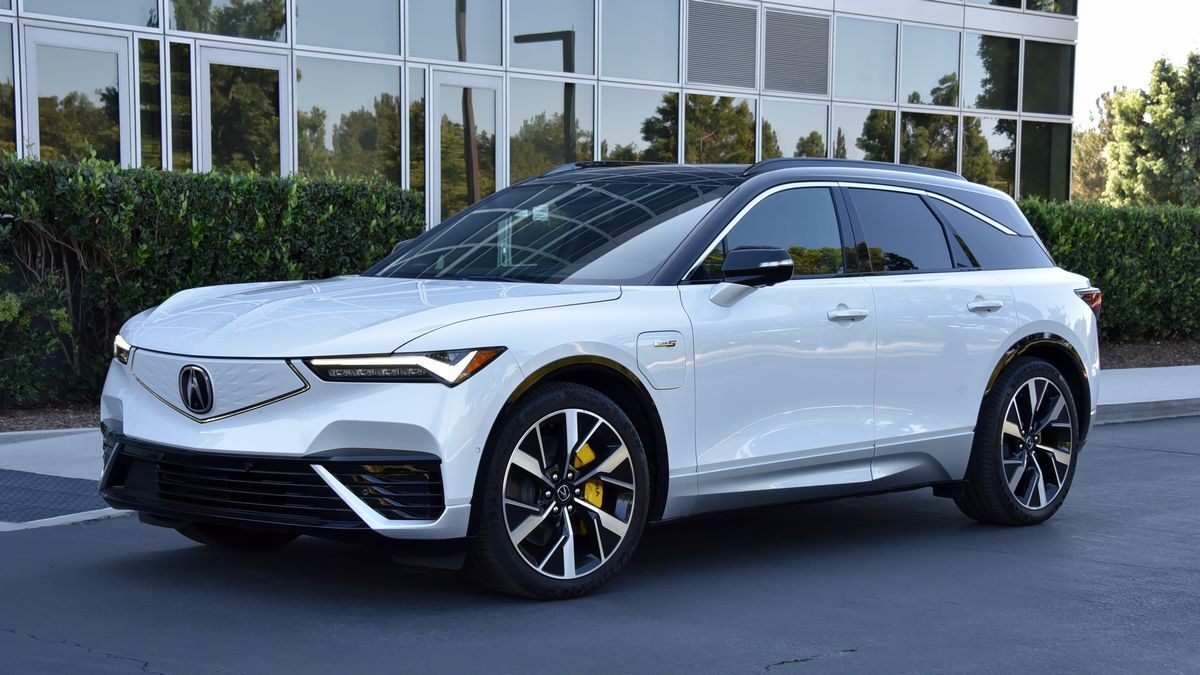 2024 Acura ZDX in white parked by bushes.