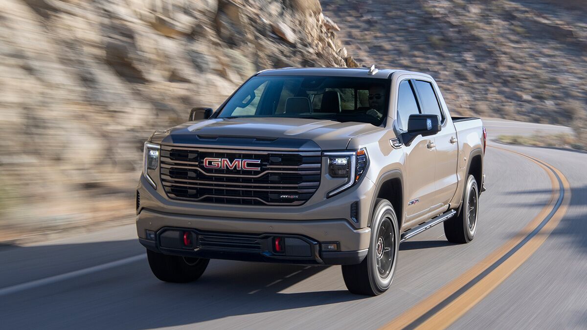2023 GMC Sierra driving on the road.